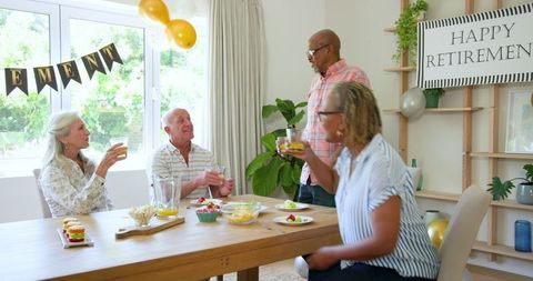 Senior friends celebrating retirement with home gathering