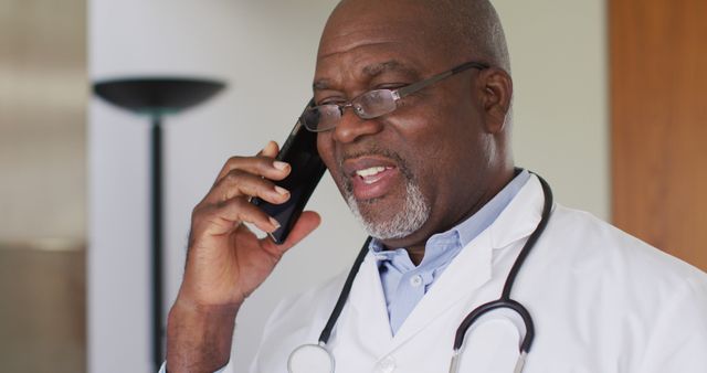 Friendly African American Doctor Talking on Phone in Office - Download Free Stock Images Pikwizard.com