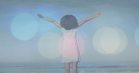 Serene Woman by Ocean with Outstretched Arms and Gentle Dreamy Flair