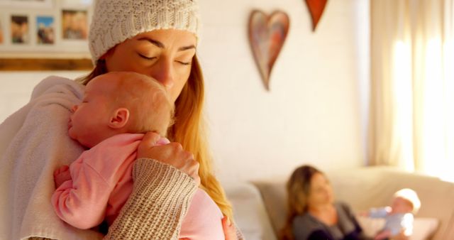 Young Mother Embracing Newborn Baby In Cozy Living Room - Download Free Stock Images Pikwizard.com