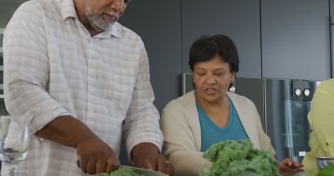 Senior Couple Cooking Together Preparing Fresh Vegetables