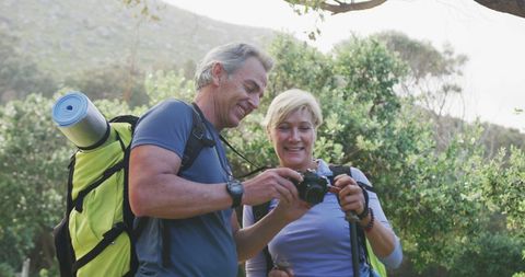 Senior Couple Enjoying Nature with Camera on Hiking Adventure - Download Free Stock Images Pikwizard.com