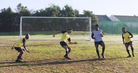 Athletic teammates training on soccer field