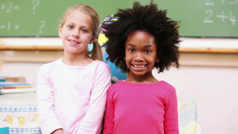 Two Girls Smiling in Classroom Setting