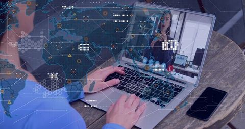 Typing on Laptop Joining Video Call While Monitoring Global Network Map for Cybersecurity