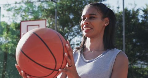Young African American Woman Holding Basketball Outdoor