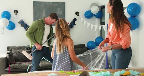 Family fun cleanup after celebration in festive living room