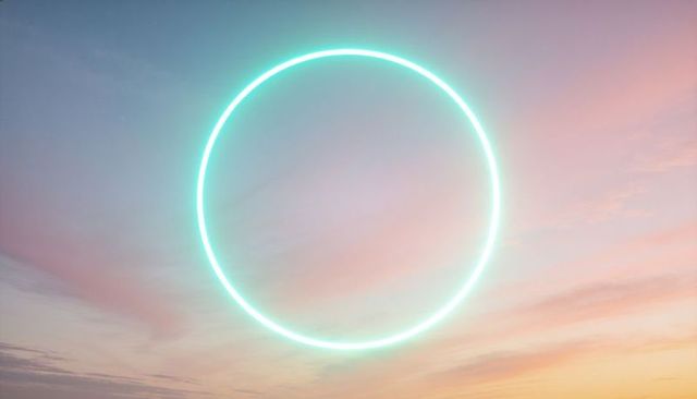 Glowing cyan neon circle hovering over pastel sunrise sky