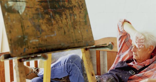 Elderly Painter Taking a Break in Atelier Amidst a Creative Session - Download Free Stock Images Pikwizard.com