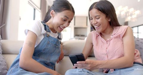 Teen Girls Bonding Over Smartphone Experience