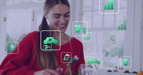 Smiling woman pouring drink in eco kitchen with green sustainability data overlays