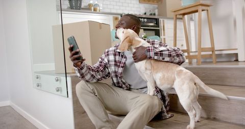 Man Enjoying Pet Companion and Smartphone at Home