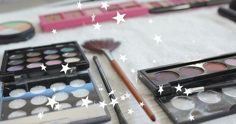 Displaying eyeshadow palettes and makeup brushes with star overlay for beauty flatlay