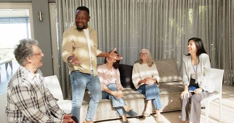 Diverse Group Engaged in Lively Therapy Discussion Indoors