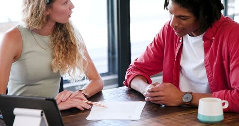 Professional team discussing business project over documents