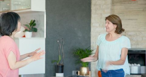 Joyful aging friends preparing for birthday celebration with balloons