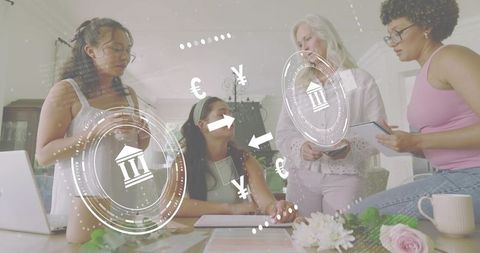 Women collaborating on fintech strategy at home table with currency and banking overlays