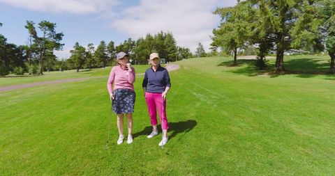 Senior women enjoying golf in lush greenery