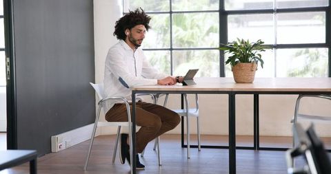 Business Professional in Modern Office Using Laptop