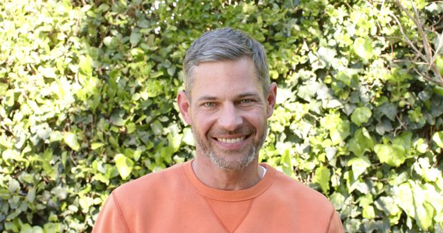 Smiling Man with Graying Hair Outdoors in Orange Sweater - Download Free Stock Images Pikwizard.com