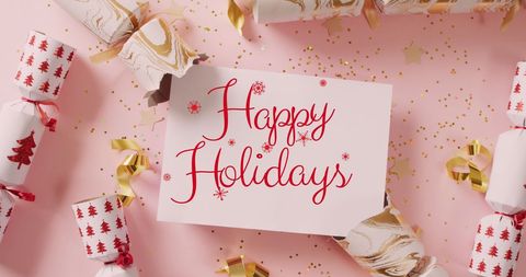 Festive holiday greeting over decorative christmas crackers
