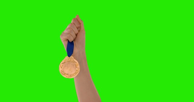 Hand hoisting gold medal, symbolizing triumph and accomplishment. Ideal for articles, advertisements, promotions related to sports, competitions, success, or recognition events.