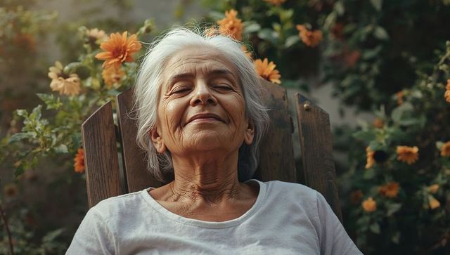 Senior woman resting in wooden chair among orange blooms at golden hour, serene portrait