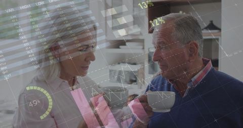 Senior Couple Discussing Finances with Digital Overlays