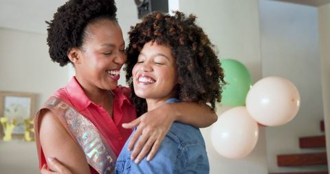 Joyful Birthday Celebration with Friends Hugging At Home