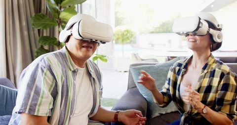 Mature Couple Enjoying Virtual Reality Experience at Home