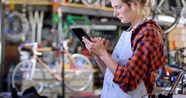 Female Bicycle Mechanic Using Tablet in Workshop - Download Free Stock Images Pikwizard.com