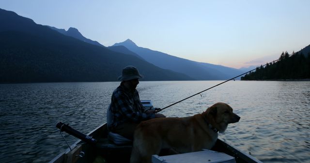 Man and Dog Fishing on Mountain Lake at Dusk - Download Free Stock Images Pikwizard.com