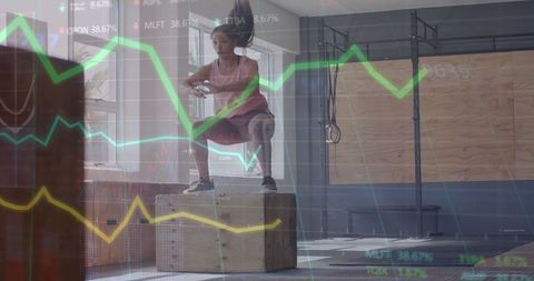 Woman box jumping in gym with data graph overlay