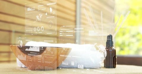 Sunlit spa table with wooden bowl, rolled towel and amber dropper bottle with ar overlays