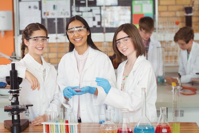 Schoolgirls in a laboratory conducting a chemical experiment, wearing lab coats and safety goggles. Ideal for educational content, science and STEM promotions, school brochures, and articles about student engagement in science.
