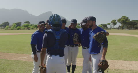 Baseball Team Strategizing Before a Game in Sunny Field