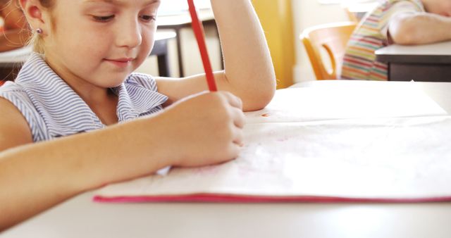 Young Girl Writing in Classroom at School - Download Free Stock Images Pikwizard.com