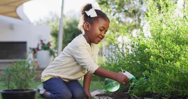 A young girl enjoying gardening outdoors on a sunny day. She is watering plants, showing care for nature. Perfect for use in articles and advertisements related to child development, outdoor activities, gardening hobbies, environmental care, and family leisure activities.