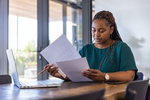 Focused businesswoman reviewing documents in office setting