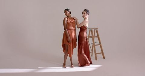 Elegant Models in Silk Dresses with Ladder