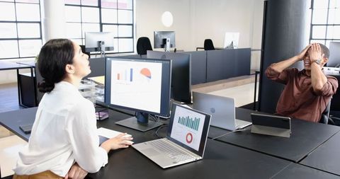 Professionals Collaborative Working on Financial Presentation in Modern Office