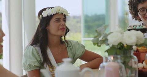 Friends enjoying wedding reception with floral decorations