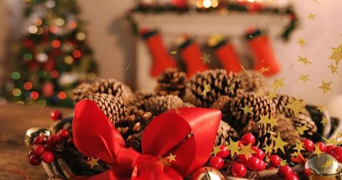 Rustic christmas centerpiece with pine cones, red satin bow and jingle bells