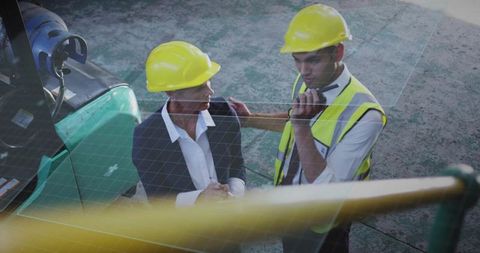 Construction supervisor guiding worker near forklift during safety briefing