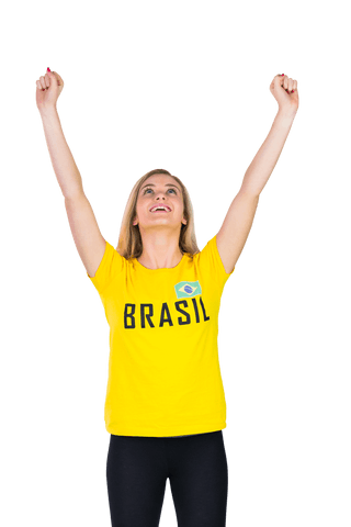 Woman celebrating with arms raised triumphantly, wearing vibrant yellow Brazil shirt. Useful for sporting events, football themes, celebrating victories, and depicting enthusiasm or team spirit in marketing.