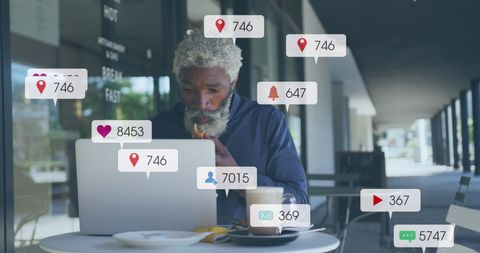 Businessman analyzing social media engagement at café