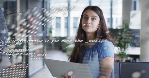 Businesswoman Analyzing Digital Data with Laptop in Modern Office