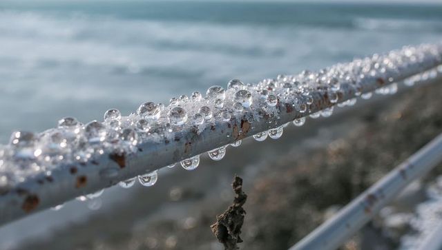 Clinging water droplets on rusted seaside railing macro coastal texture and patina