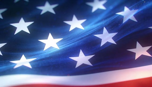 Waving american flag stars close-up with luminous fabric texture and festive bokeh