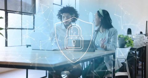 Discussing cybersecurity with digital shield and padlock overlay in modern office